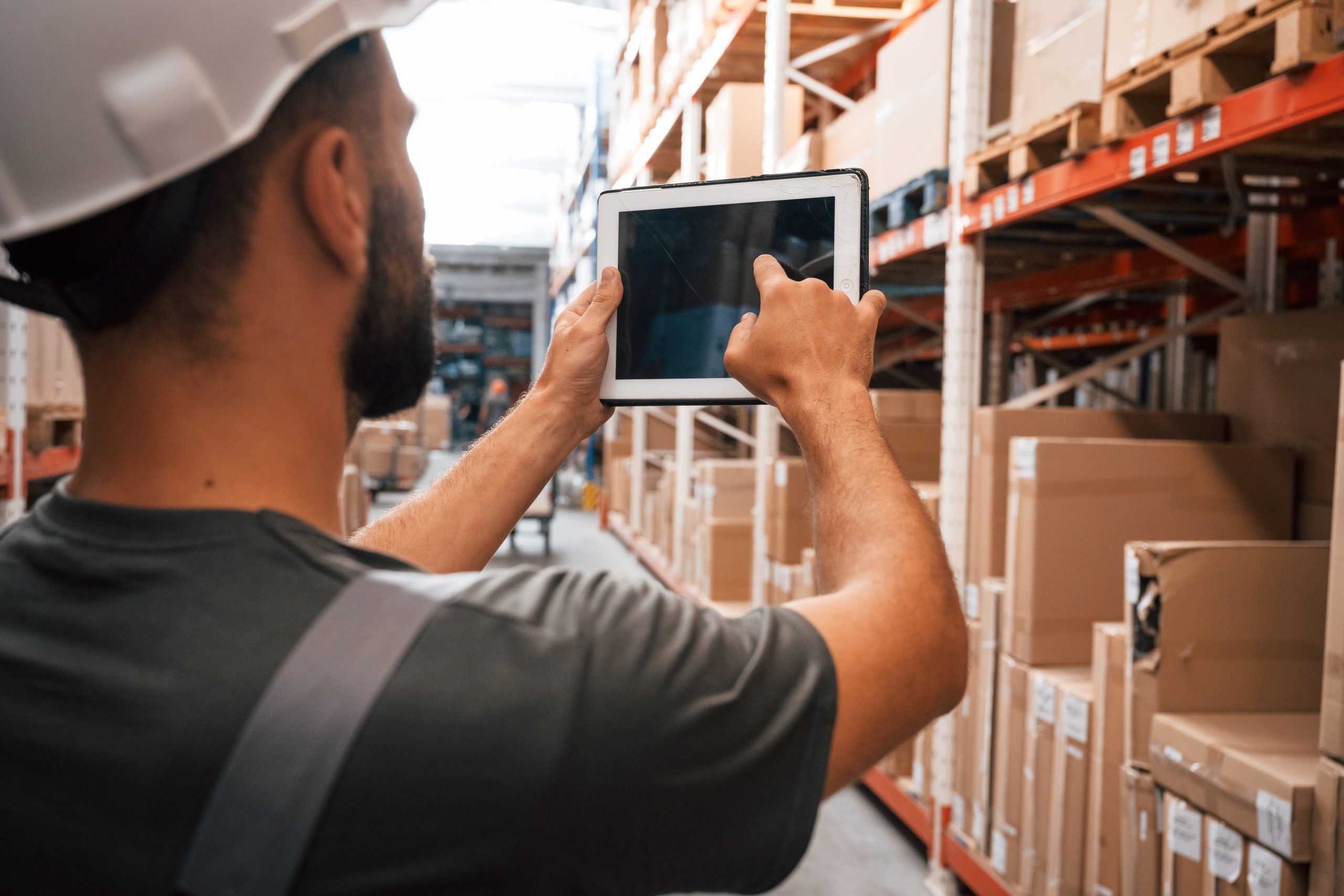 using the digital tablet. foreman is in the storehouse, shipping distribution business